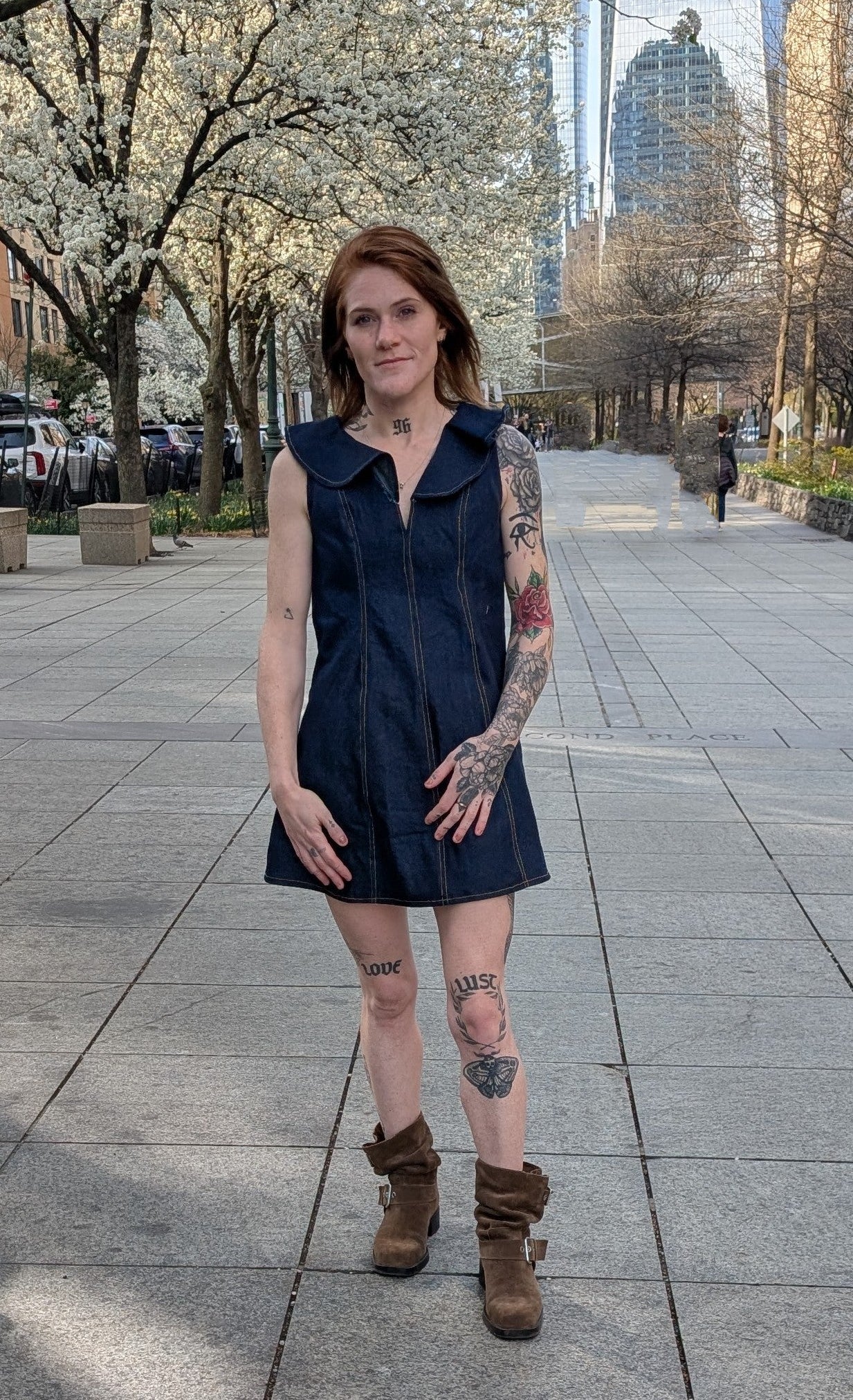 Model wearing Ruffle A-Line Denim Mini Dress styled with boots