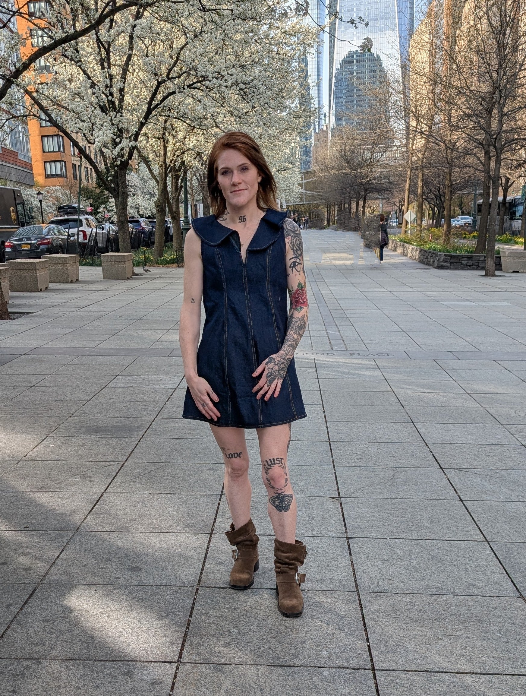 Model wearing Ruffle A-Line Denim Mini Dress styled with boots