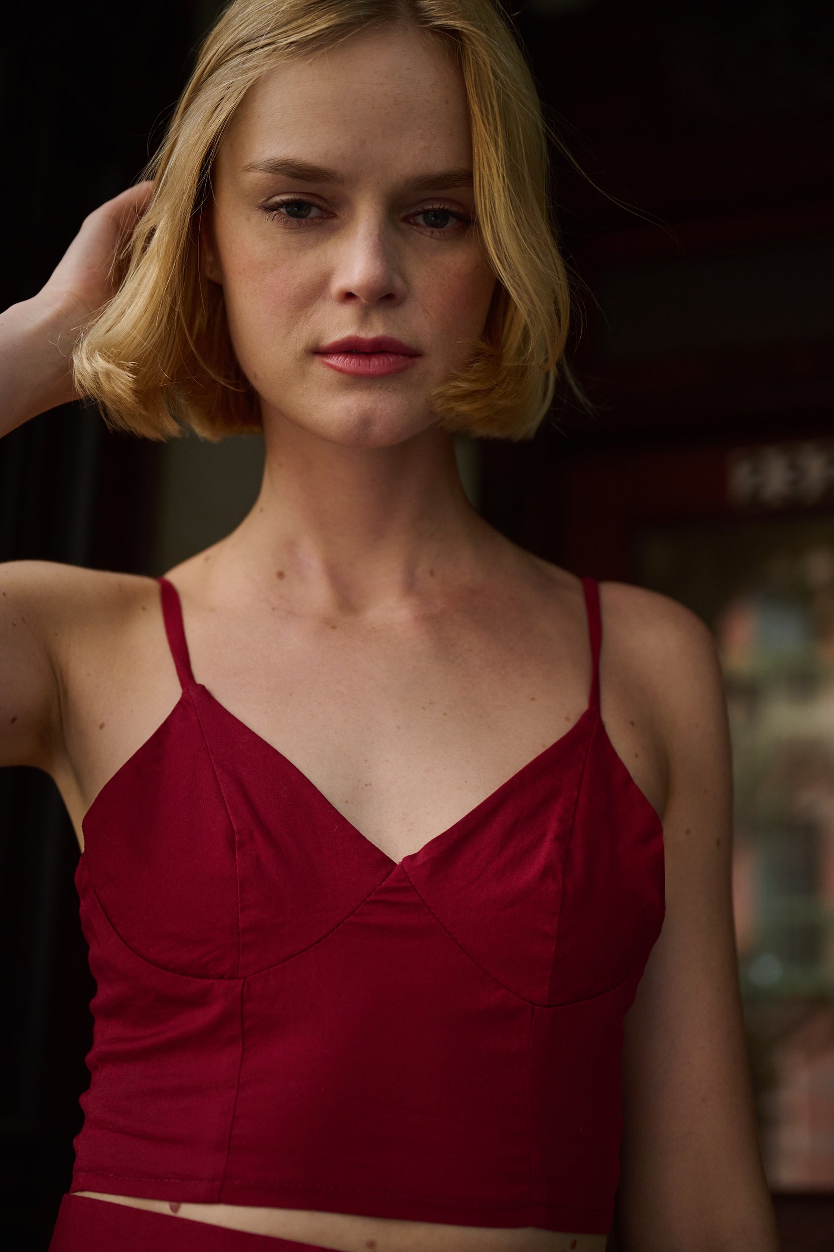 Woman wearing a red top with a blurred background