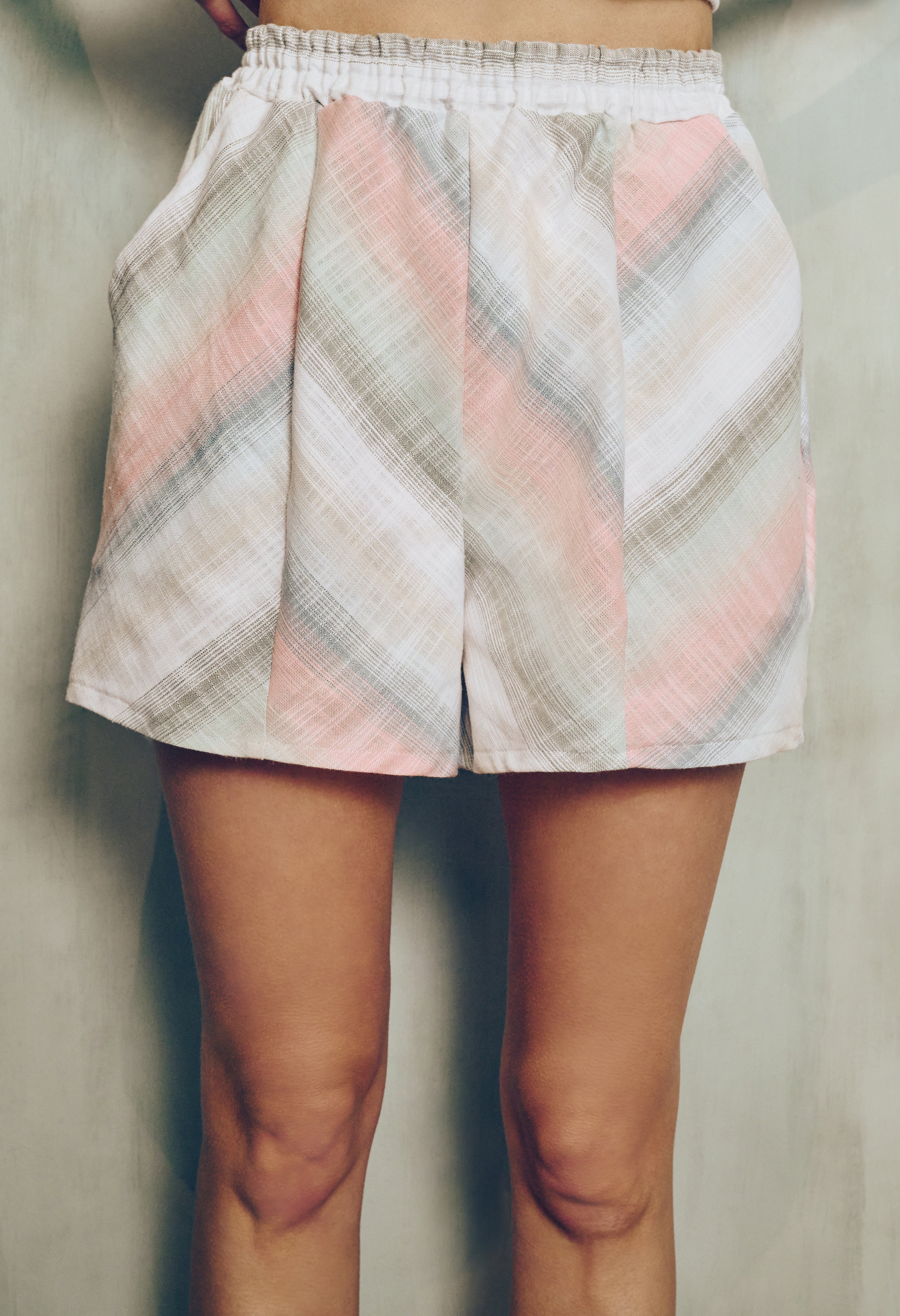 zig zag stripe shorts worn by a woman on a plain background